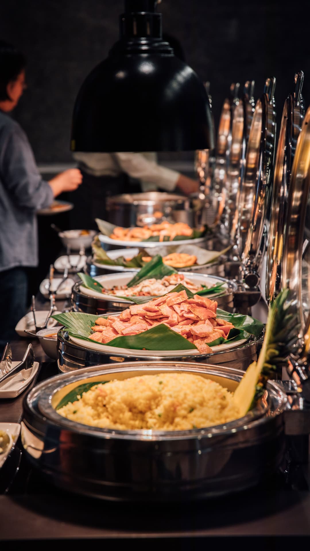 Warm buffet service with rice and carved meats under heat lamps